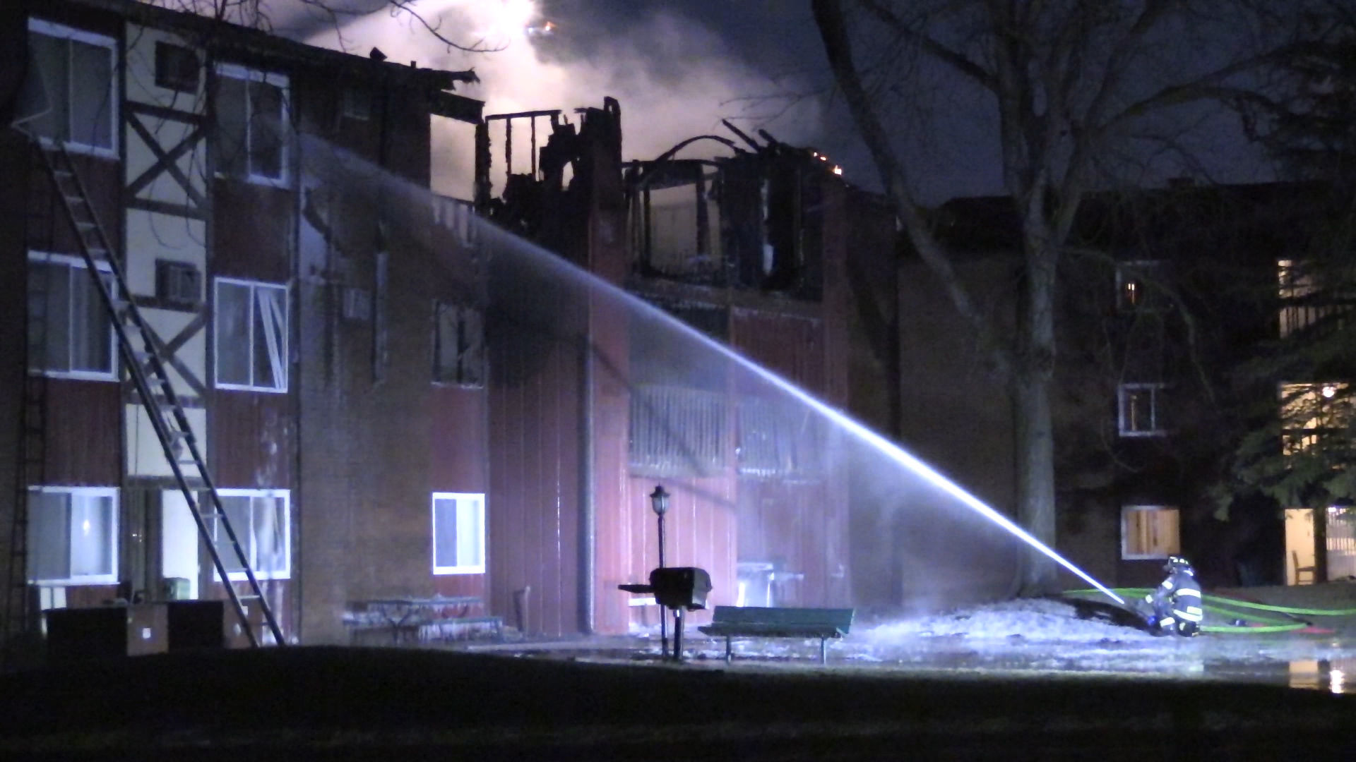 Firefighters continue to battle apartment building fire
